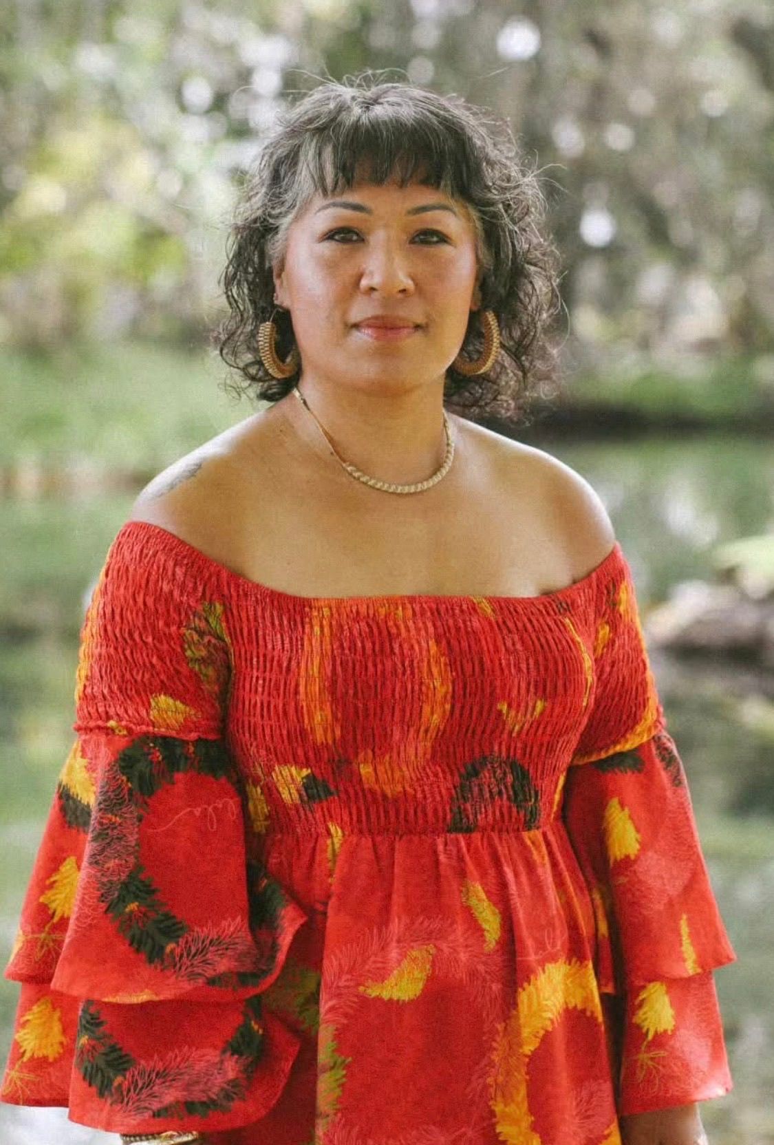 Andrea Mondoy-Honaker, President candidate, wearing a red floral dress