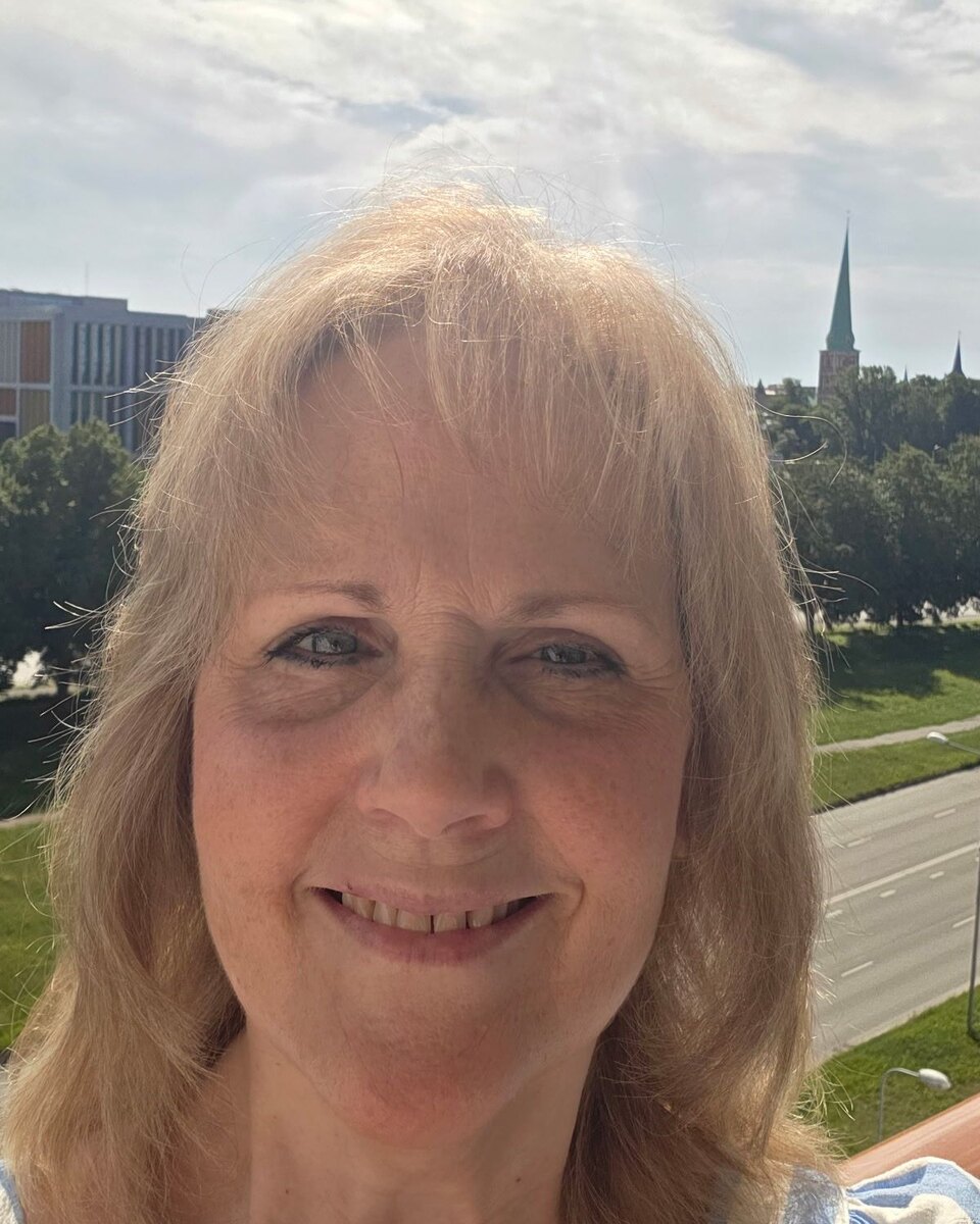 Sandra Hogan, Auditor candidate, smiling outdoors with shoulder-length blonde hair